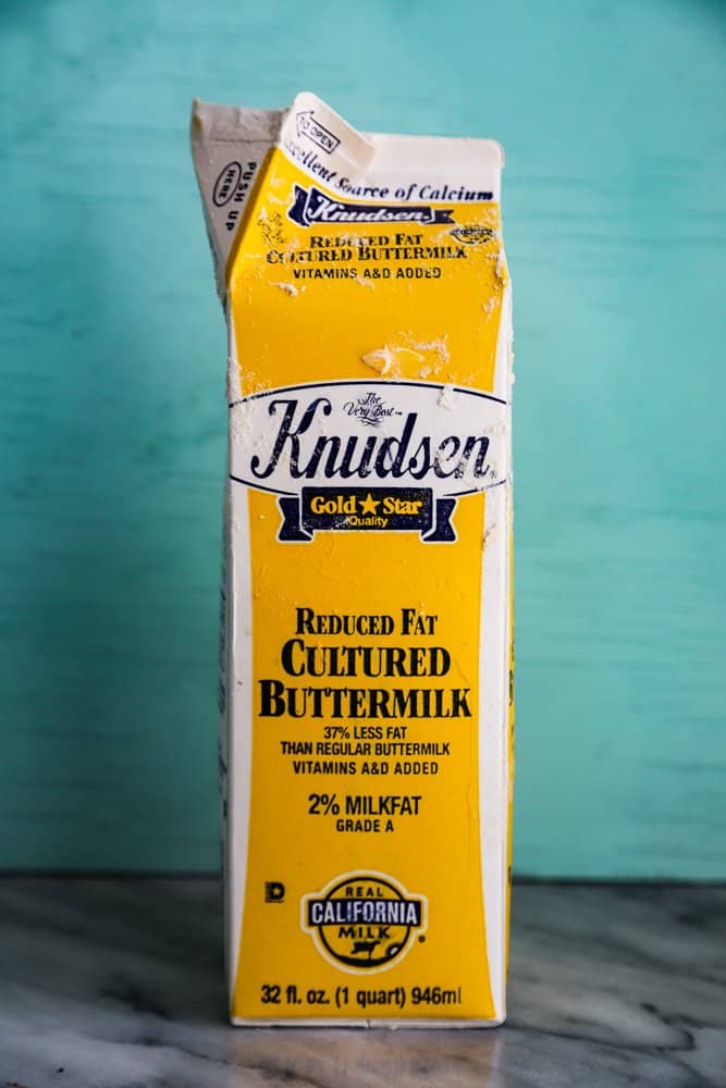 A yellow carton of buttermilk, covered in flour.